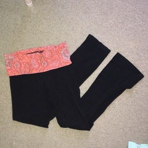 Black athletic yoga pants with a pink waist band.